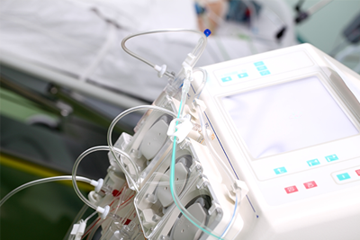 Hemodialysis Machine next to a hospital bed.